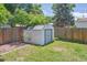 Backyard storage shed near a wooden fence and green lawn offering practical outdoor organization at 1774 S Dover Way, Lakewood, CO 80232