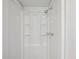 All white shower with adjustable showerhead and built-in shelving for storage at 1774 S Dover Way, Lakewood, CO 80232