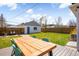 Spacious backyard featuring a large deck with a picnic table and sunny skies at 4374 S Washington St, Englewood, CO 80113