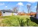 Large, well-maintained backyard with a wooden fence, deck, and patio at 4374 S Washington St, Englewood, CO 80113