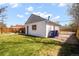 This backyard features a well-manicured lawn, patio, and a detached garage with alley access at 4374 S Washington St, Englewood, CO 80113