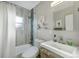 Modern bathroom featuring stylish tile accents, a sleek vanity, and a shower-tub combination for relaxing at 4374 S Washington St, Englewood, CO 80113