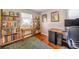 Bright bedroom featuring a full wall of bookshelves and a light-filled workspace at 4374 S Washington St, Englewood, CO 80113