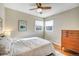 Comfortable bedroom with hardwood floors, a ceiling fan, and a large dresser at 4374 S Washington St, Englewood, CO 80113
