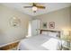 Bright bedroom with light walls, hardwood floors, and natural light from the window at 4374 S Washington St, Englewood, CO 80113