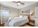 Charming bedroom with hardwood floors, neutral walls, and a comfortable queen-sized bed bathed in natural light at 4374 S Washington St, Englewood, CO 80113