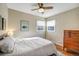 Comfortable bedroom with hardwood floors, a ceiling fan, and a large dresser at 4374 S Washington St, Englewood, CO 80113