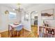 Dining room area with modern lighting fixtures and a view into the bright kitchen at 4374 S Washington St, Englewood, CO 80113