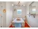 Bright dining room featuring hardwood floors, modern lighting, and a view to the outside through the window at 4374 S Washington St, Englewood, CO 80113