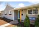 Detailed view of home's architectural details, including the porch and well-kept yard at 4374 S Washington St, Englewood, CO 80113