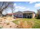 Charming home featuring a well-manicured lawn, mature trees, and attractive drought-tolerant landscaping at 4374 S Washington St, Englewood, CO 80113