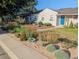 Charming home with drought-friendly landscaping, a stone pathway, and well-maintained greenery at 4374 S Washington St, Englewood, CO 80113