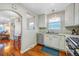 The kitchen has stainless appliances, white cabinets, and flows into the adjacent dining room at 4374 S Washington St, Englewood, CO 80113