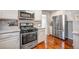 Well-equipped kitchen with stainless steel appliances, white cabinetry, and granite countertops offers both style and functionality at 4374 S Washington St, Englewood, CO 80113