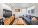 Bright living room with a plush sectional couch, stylish coffee table, and ample natural light at 4374 S Washington St, Englewood, CO 80113