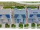 Aerial view of rooftops with solar panels surrounded by lawns and streets at 10387 Harrisburg St, Parker, CO 80134
