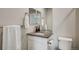 Bathroom features granite countertops, a large mirror and toilet at 10387 Harrisburg St, Parker, CO 80134