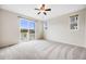 Spacious bedroom with sliding glass doors to balcony, offering plenty of natural light and airy feel at 10387 Harrisburg St, Parker, CO 80134