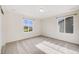 Bedroom with two bright windows and neutral carpet at 10387 Harrisburg St, Parker, CO 80134