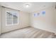 Bedroom with natural light from three bright windows and neutral carpet at 10387 Harrisburg St, Parker, CO 80134