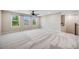 Spacious bonus room with plush carpet and views from bright windows at 10387 Harrisburg St, Parker, CO 80134
