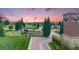 Scenic community park featuring walking paths, lush landscaping, seating, and a picturesque gazebo under a colorful sunset sky at 10387 Harrisburg St, Parker, CO 80134