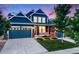 Charming home featuring a well-manicured lawn, attached garage, and a welcoming front porch at 10387 Harrisburg St, Parker, CO 80134