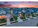Aerial view of homes featuring professionally landscaped yards, solar panels, long driveways, and inviting curb appeal at 10387 Harrisburg St, Parker, CO 80134