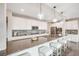 Gourmet kitchen with a large center island, stylish pendant lighting, and modern appliances at 10387 Harrisburg St, Parker, CO 80134