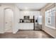 Charming kitchenette with stainless steel appliances, white cabinets, and a stylish backsplash at 10387 Harrisburg St, Parker, CO 80134