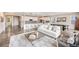 Open concept living room with modern decor and a seamless flow to the kitchen at 10387 Harrisburg St, Parker, CO 80134