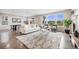 Bright and airy living room with large windows, a cozy rug, and comfortable seating at 10387 Harrisburg St, Parker, CO 80134