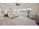 Spacious main bedroom with tray ceiling, ceiling fan, and three large windows at 10387 Harrisburg St, Parker, CO 80134