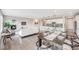 Open-concept living and dining area with a fireplace, modern furnishings, and seamless flow at 10387 Harrisburg St, Parker, CO 80134