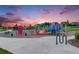 Community playground with colorful equipment and safety surfacing at 10387 Harrisburg St, Parker, CO 80134