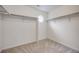Bright walk-in closet featuring neutral carpet and shelving at 10387 Harrisburg St, Parker, CO 80134