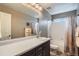 Standard bathroom with white cabinets, large mirror, single sink, and tub shower at 23503 E Minnow Dr, Aurora, CO 80016