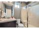 Modern bathroom features a tiled shower with bench, a dark vanity, and updated fixtures at 23503 E Minnow Dr, Aurora, CO 80016
