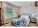 Charming bedroom with a decorative accent wall, large window, and comfortable bed at 23503 E Minnow Dr, Aurora, CO 80016