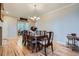 Inviting dining room features hardwood floors, a large dining table, and elegant chandelier lighting at 23503 E Minnow Dr, Aurora, CO 80016