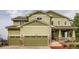 Charming two-story home featuring a well-manicured lawn and an attached two-car garage at 23503 E Minnow Dr, Aurora, CO 80016