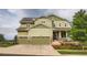 Two story home with a two-car garage, inviting porch, and manicured lawn at 23503 E Minnow Dr, Aurora, CO 80016