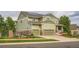 View of the front of the home, featuring a two-car garage and nicely landscaped yard at 23503 E Minnow Dr, Aurora, CO 80016