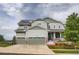 Lovely two-story home with a two-car garage, covered front porch, and beautifully landscaped front yard at 23503 E Minnow Dr, Aurora, CO 80016