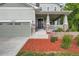 Welcoming home with a two-car garage, covered porch, and professionally landscaped front yard for curb appeal at 23503 E Minnow Dr, Aurora, CO 80016
