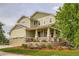This two-story home features a covered porch, tasteful landscaping, and an attached two-car garage at 23503 E Minnow Dr, Aurora, CO 80016
