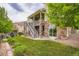 Beautiful home exterior with covered patio, stone accents, steps, and lush landscaping at 23503 E Minnow Dr, Aurora, CO 80016