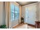 Bright foyer with hardwood floors, a large window, and a view of the front door at 23503 E Minnow Dr, Aurora, CO 80016