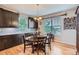 Cozy kitchen with dark wood cabinets, granite countertops, a dining table, and natural light at 23503 E Minnow Dr, Aurora, CO 80016