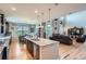 Bright open kitchen, dining, and living space offers an island with seating and stainless steel appliances at 23503 E Minnow Dr, Aurora, CO 80016